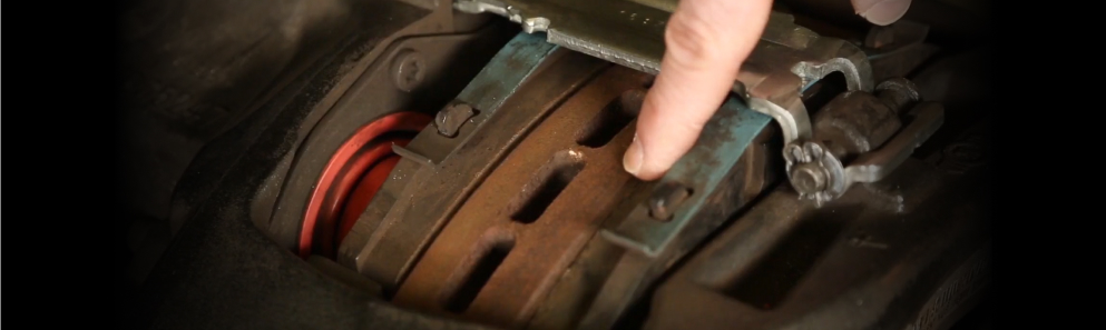 Technician inspecting the rotor on a heavy-duty air disc brake assembly