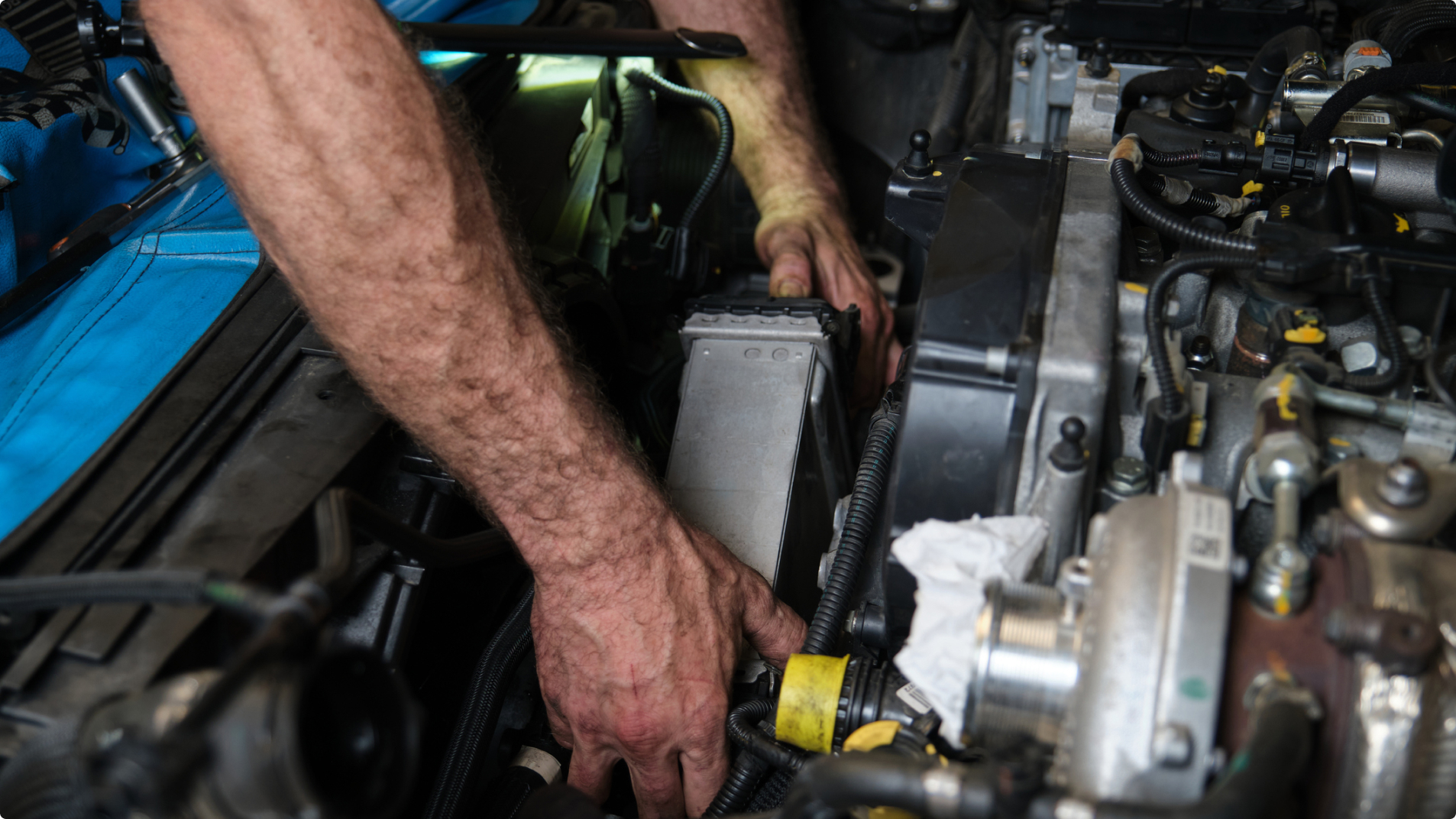 Technician Inspecting Vehicle Engine