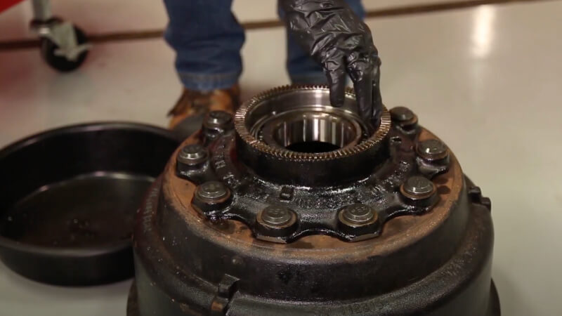 Man lubricating bearing with oil