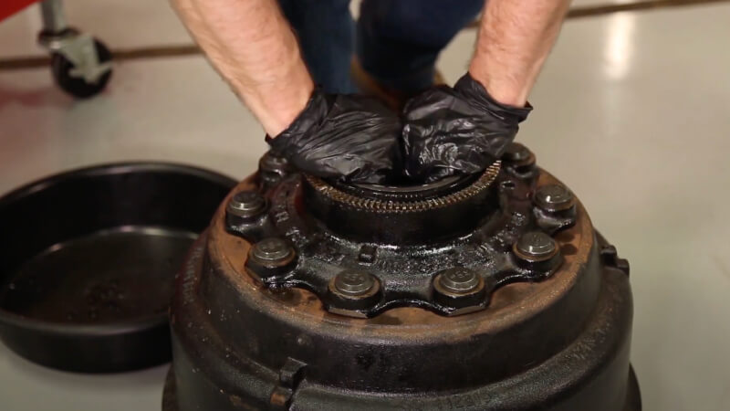 man pressing wheel end seal down evenly