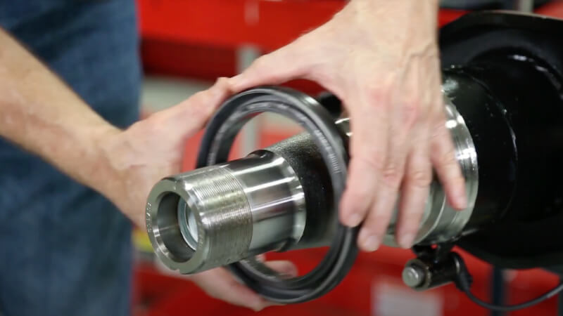 man placing spindle seal on front edge of the seal journal