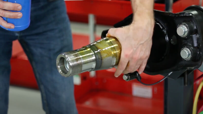 man lubricating spindle with oil