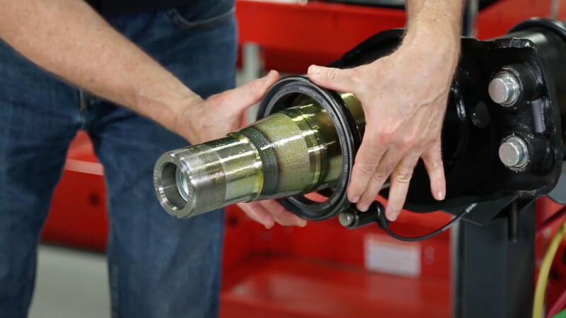man installing new seal on spindle