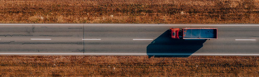 aerial view of red truck on rural highway